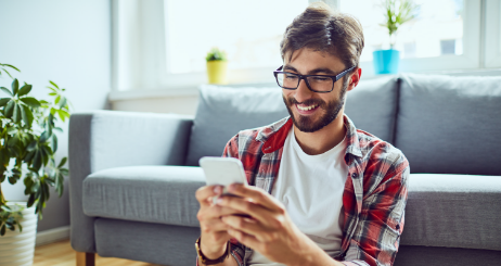 Man In Living Room With Phone