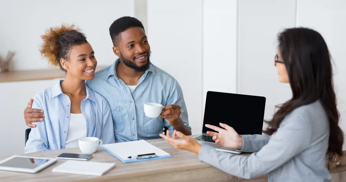 Couple conversing with agent