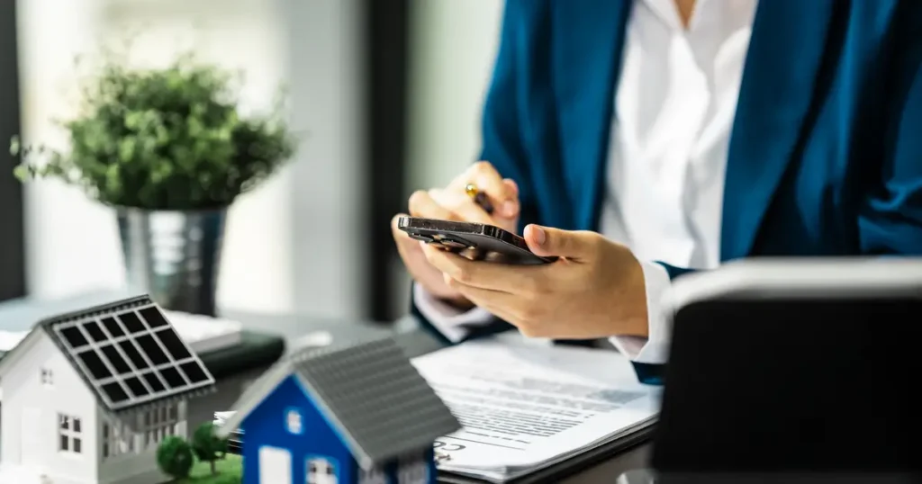 Hands holding calculator with documents